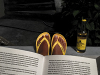 self-portrait while reading a good book with yellow flip-flops and wine with yellow label