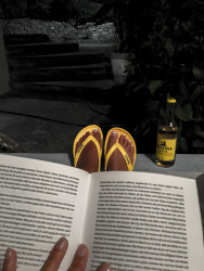 self-portrait while reading a good book with yellow flip-flops and wine with yellow label
