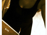 self-portrait in a little black dress with calender 2018 in sepia