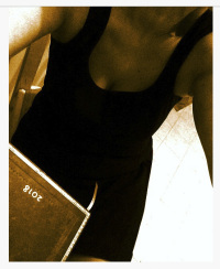 self-portrait in a little black dress with calender 2018 in sepia