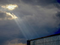 sun rays are shining between clouds on a hall