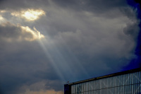 sun rays are shining between clouds on a hall