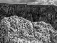 the harsh mountains of vikos canyon in epirus under a cloudy sky, black-and-white