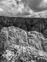 the harsh mountains of vikos canyon in epirus under a cloudy sky, black-and-white