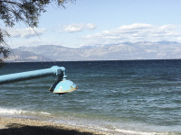 a blue dripping shower at the beach of the gulf of corinth