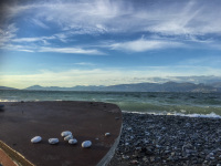 a handful stones is laying on a fisher boat at the stony beach of the gulf of corinth