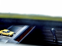 view through the open window of a oldtimer bmw e28 to the same car as a little model