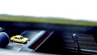 view through the open window of a oldtimer bmw e28 to the same car as a little model