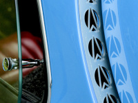 light blue oldtimer with nice details and with a view through a quarter glass to a red leather seat