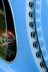 light blue oldtimer with nice details and with a view through a quarter glass to a red leather seat