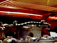 view under the engine hood of an orange oldtimer