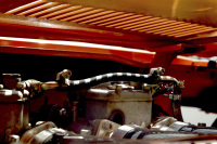 view under the engine hood of an orange oldtimer