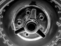 a chrome rim of a ford mustang oldtimer, black-and-white
