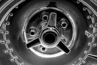 a chrome rim of a ford mustang oldtimer, black-and-white