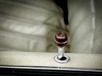 an oldtimer has beige leather seats and a lock knob with a brown wooden head