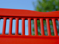 the ventilation slots of a red oldtimer in front of a blue sky