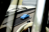 on the dashboard of a mercedes benz oldtimer the owner presents his car in a light blue small model
