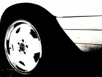 the rear tire of a mercedes benz oldtimer with matching rim, black-and-white