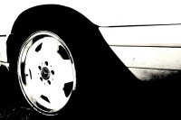 the rear tire of a mercedes benz oldtimer with matching rim, black-and-white