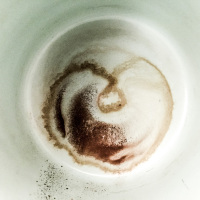 a coffee grounds in a mint colored cup looks like a heart
