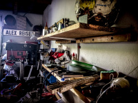 two shelves full of various stuff and tools in a cosy workshop