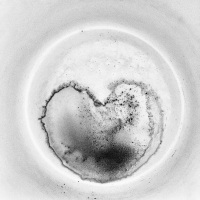 this coffee grounds looks like a thick round heart, black-and-white
