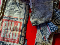 a pull tab, a small wooden board, an old peace of the newspaper Bild from 1980 and an old crossword puzzle