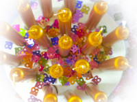 top view of golden candles with many little colorful 18-numbers for the 18. birthday