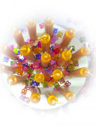 top view of golden candles with many little colorful 18-numbers for the 18. birthday