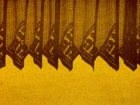 old lace curtains in front of a yellow roller blind