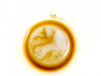 a light brown coffee ground in a white cup