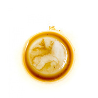 a light brown coffee ground in a white cup