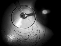 the foot of a glass of wine is standning on a table with traces of wine