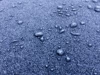 wunderful ice flowers on the engine hood of a black bmw e60