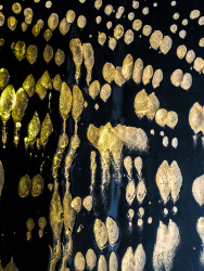 the sun is shining on dabs of foam on a mirror