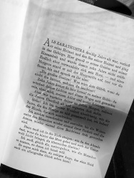 on the first page of the book thus spoke zarathustra by friedrich  nietzsche there is a shadow of a glass of wine, black-and-white
