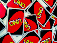 some mixed cards of the game uno are laying on a table