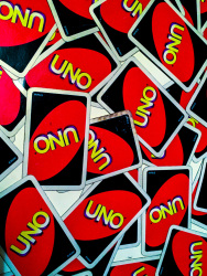 some mixed cards of the game uno are laying on a table