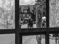 through an old window you visitors of a market of arts and crafts in hermannsburg, black-and-white