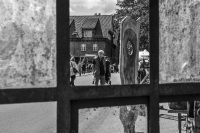 through an old window you visitors of a market of arts and crafts in hermannsburg, black-and-white