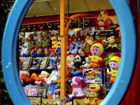 in an oval mirror with a lightblue edge you see the puppets for win at a lottery booth at the laurentius market in müden örtze