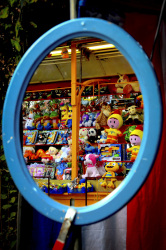 in an oval mirror with a lightblue edge you see the puppets for win at a lottery booth at the laurentius market in müden örtze