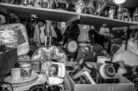 visitors rummage in many stuff on a flea market at the evangelical mission in hermannsburg, black-and-white