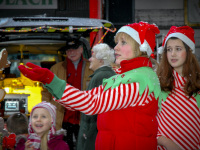 on a market in faßberg two young woman are dressed up as christmas elves and wondering falling snowflakes