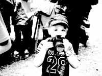 a little boy with a camera wants to photograph the photographer on a market in bergen
