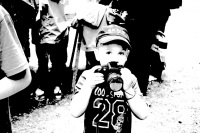a little boy with a camera wants to photograph the photographer on a market in bergen