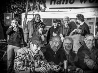 at a hunter meeting in müden örtze some hunters are laughing about the imitated sound of a deer wild call, black-and-white