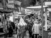 visitors of the laurentius market in müden are seeking protection at the stands for a downpour, black-and-white