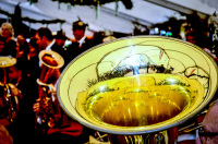 in front of celebrating guests of the rifle club festival in bergen the music band is playing, inter alia a yellow shiny tuba