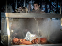 a young man seams pleasantly surprised about a hot meat meal at a christmas market in faßberg